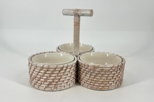 Three woven wicker baskets with ceramic liners arranged around a central wooden handle, forming a decorative trio for storage or serving