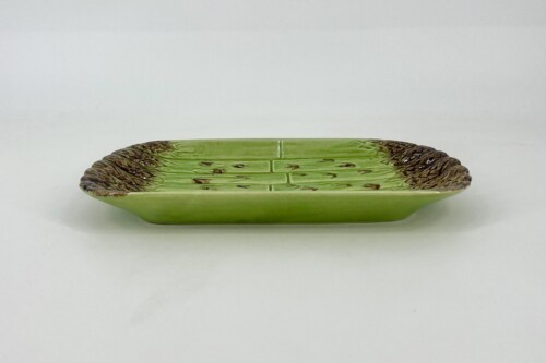 Green ceramic serving platter with a brown, ruffled edge and divided sections.