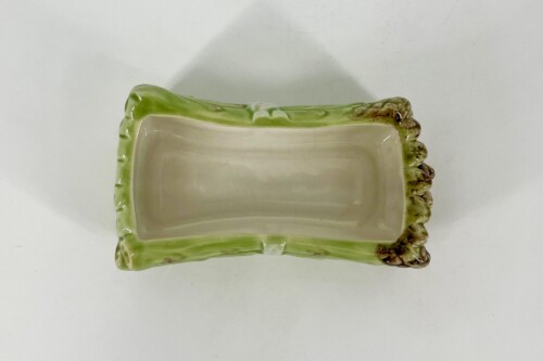 Top-down view of a rectangular ceramic planter with a green glazed rim and beige interior.
