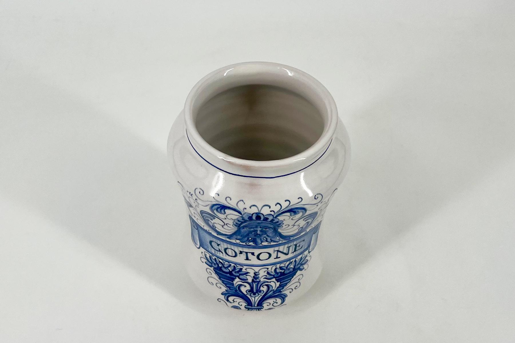 White porcelain vase with cobalt-blue floral scroll pattern and glossy glaze, shown from the top with an open mouth