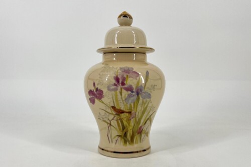 Beige ceramic lidded vase with a colorful floral iris design and gold accents on the rim and base.