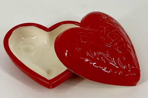 Red heart-shaped box, open to show white interior and red rim.