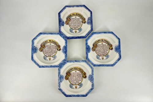 Set of hexagonal ceramic plates with blue patterned rims arranged in a cross, each featuring circular Italian recipe text in the center