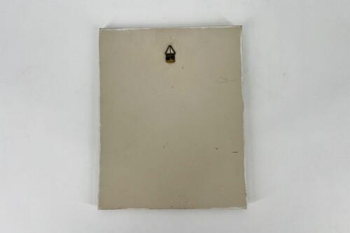 Beige rectangular panel mounted on a white wall with a small metal hanging hook at its top center.