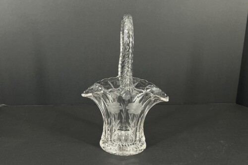 Crystal compote with a tall twisted stem and etched leaf design, set on a dark surface