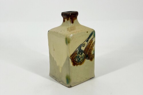 Cream-glazed ceramic bottle with a brown neck and a hand-painted fish motif in green and brown.