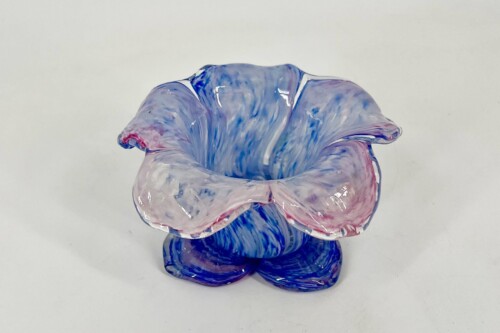Colorful blown-glass sculpture with blue, pink, and white swirls forming a knot-like shape.