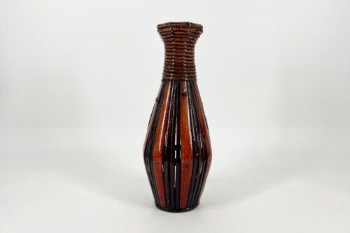 Decorative brown glass vase with vertical woven slats and a wrapped neck, on a white surface