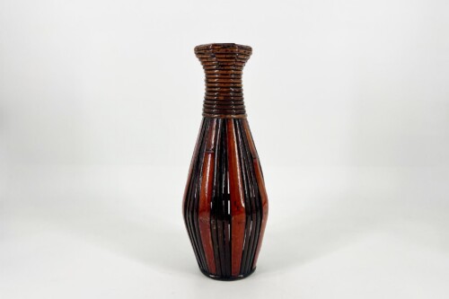 Brown glass bottle with vertical woven slats spiraling up the neck, set against a white background (decorative vase).